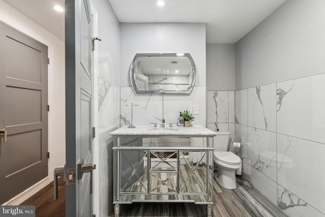 bathroom featuring tile walls, a shower with shower curtain, and hardwood / wood-style flooring