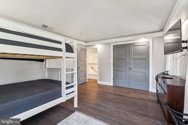 unfurnished bedroom featuring dark wood-type flooring and crown molding