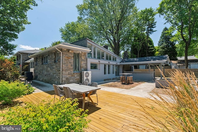 back of property featuring a deck and central AC unit