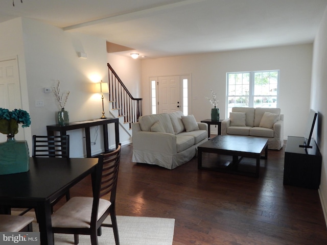 living room with dark wood-type flooring and beam ceiling