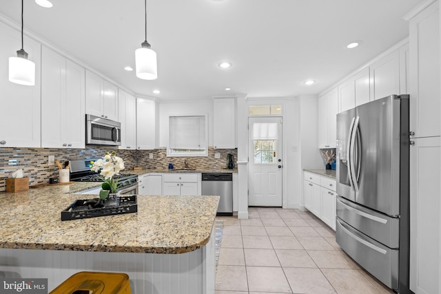 kitchen with white cabinetry, kitchen peninsula, hanging light fixtures, and appliances with stainless steel finishes