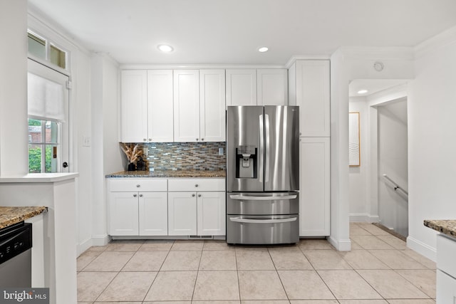 kitchen featuring white cabinets, crown molding, decorative backsplash, light stone countertops, and stainless steel appliances