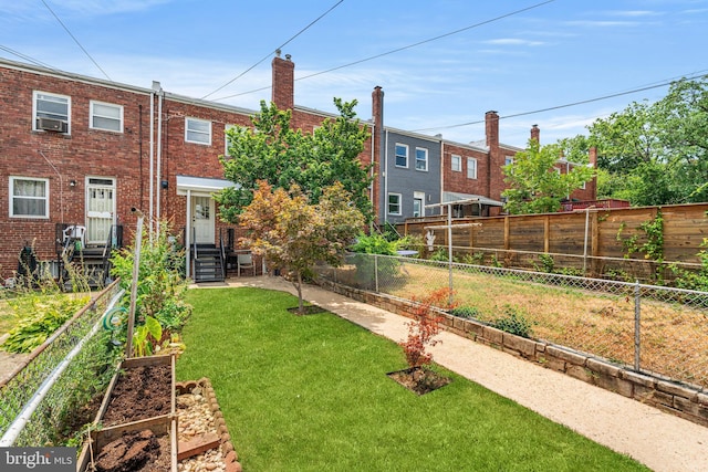 back of property featuring a lawn and cooling unit