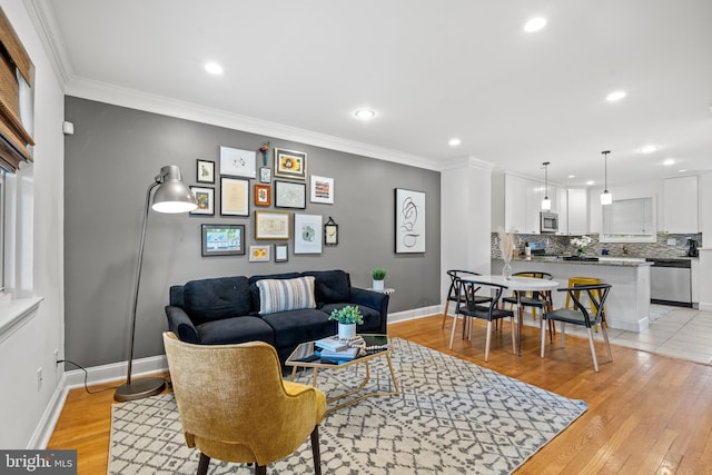 living room with light hardwood / wood-style floors and ornamental molding