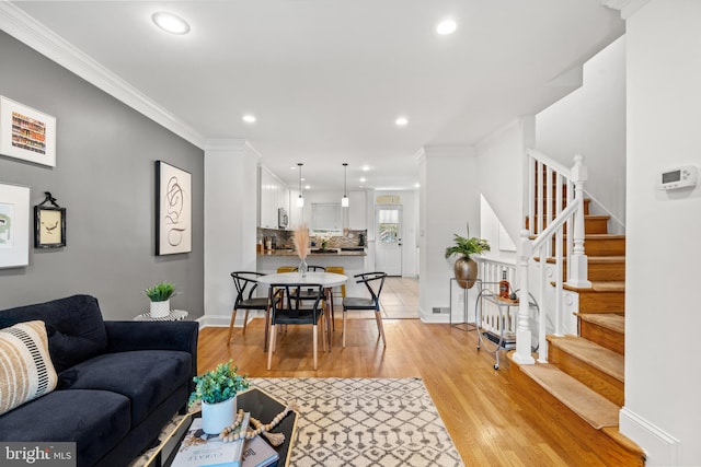 living room with light hardwood / wood-style floors and crown molding