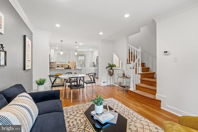 living room featuring crown molding and light wood-type flooring