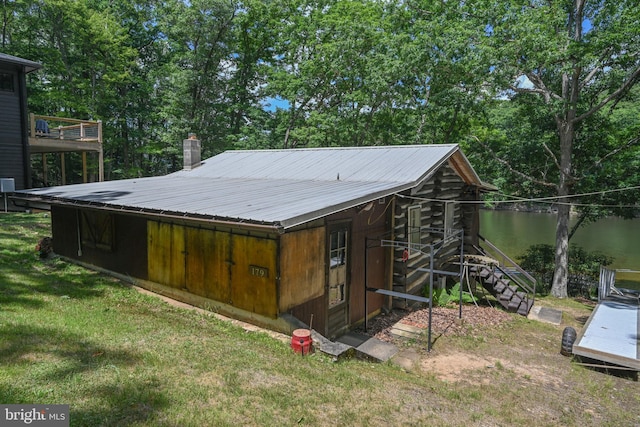 view of outdoor structure featuring a yard and a water view