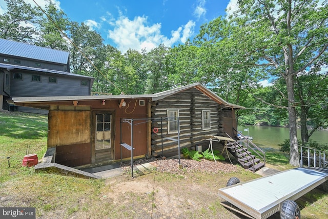 rear view of house featuring a water view