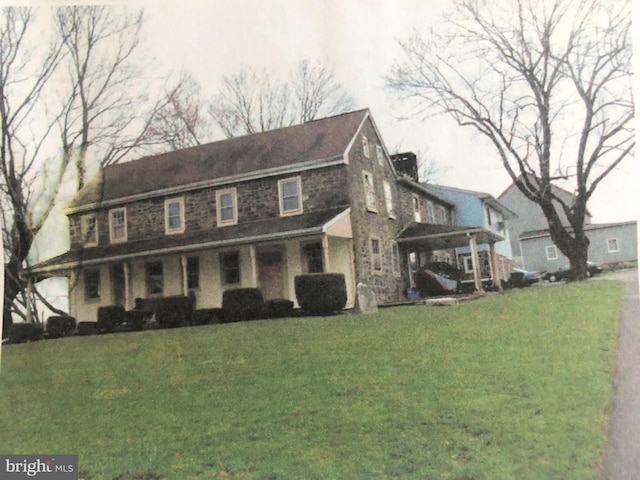 view of home's exterior with a yard and a carport