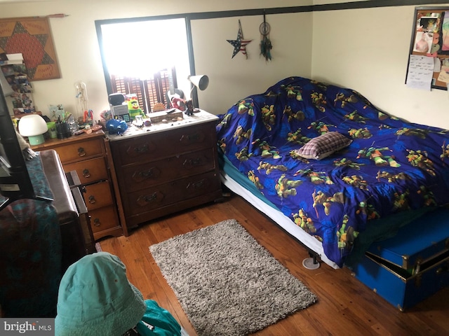 bedroom with hardwood / wood-style flooring