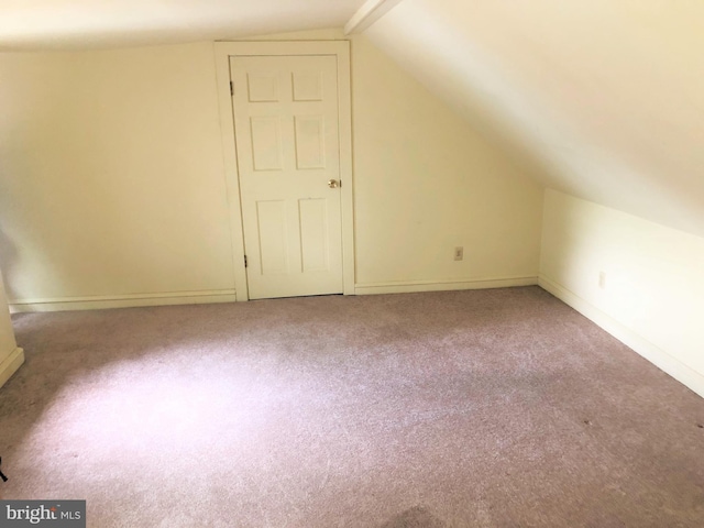 additional living space with carpet floors and lofted ceiling