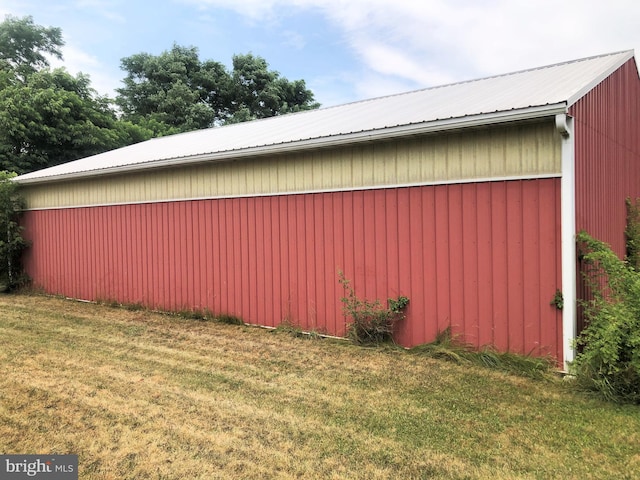 view of property exterior featuring a yard and an outdoor structure