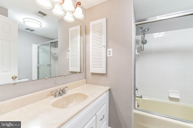 bathroom featuring vanity and combined bath / shower with glass door