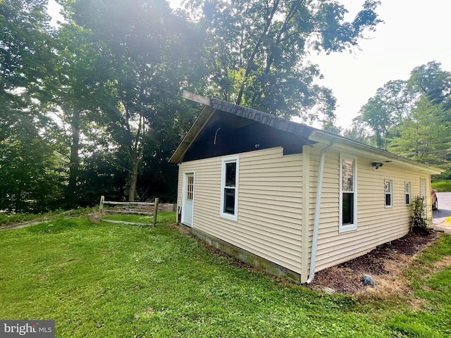 view of property exterior with a yard