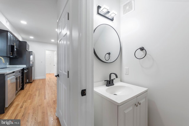 bathroom featuring vanity and wood-type flooring