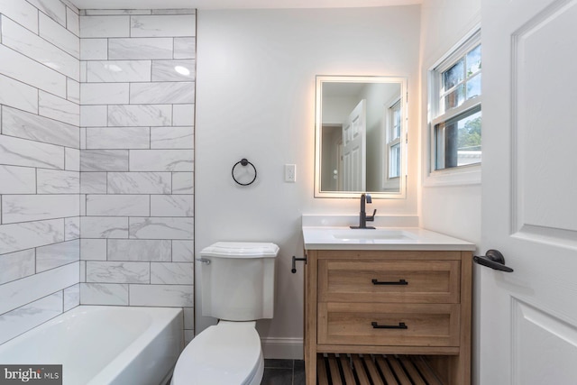 full bathroom with tiled shower / bath, vanity, and toilet