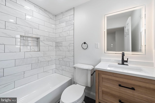 full bathroom featuring vanity, toilet, and tiled shower / bath combo