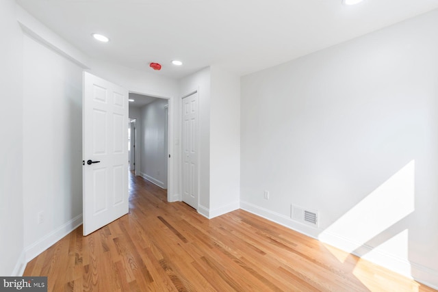 empty room with light hardwood / wood-style flooring