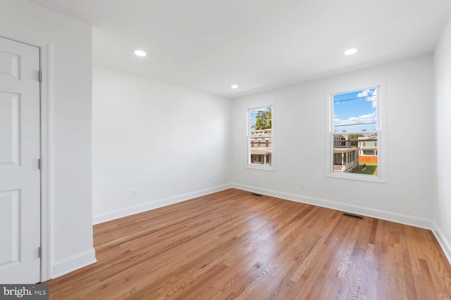 spare room featuring light wood-type flooring