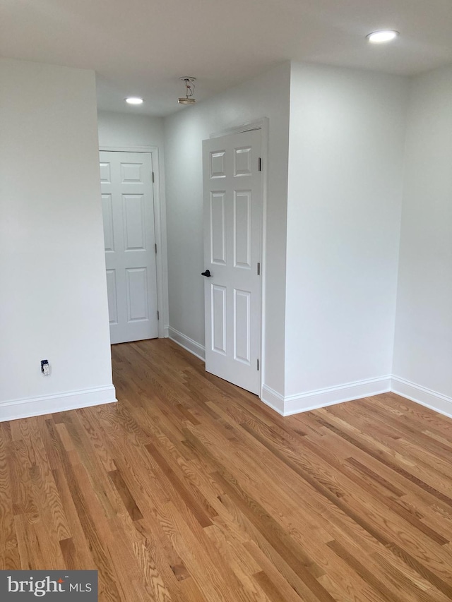 spare room with light wood-type flooring