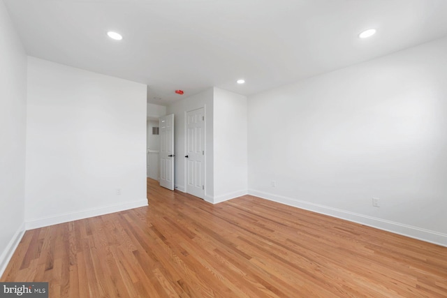 empty room with light hardwood / wood-style floors