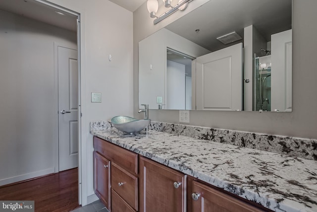 bathroom with vanity and hardwood / wood-style flooring