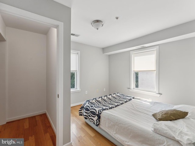 bedroom with hardwood / wood-style floors