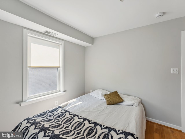 bedroom with hardwood / wood-style floors