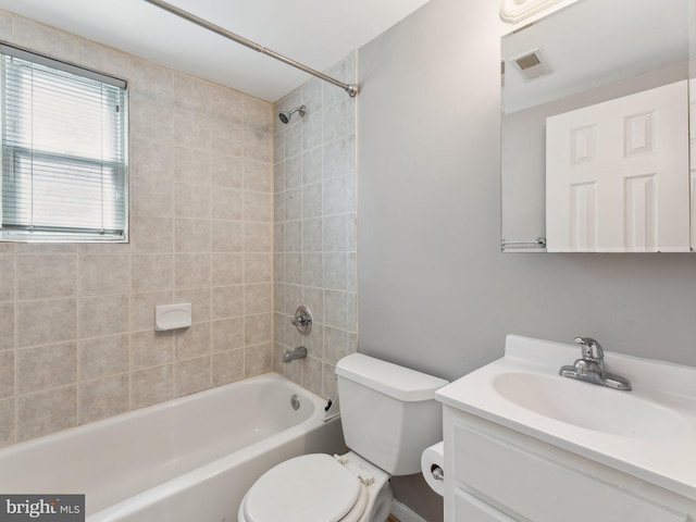 full bathroom with toilet, vanity, and tiled shower / bath combo