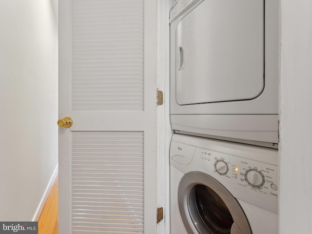 washroom featuring stacked washer and clothes dryer