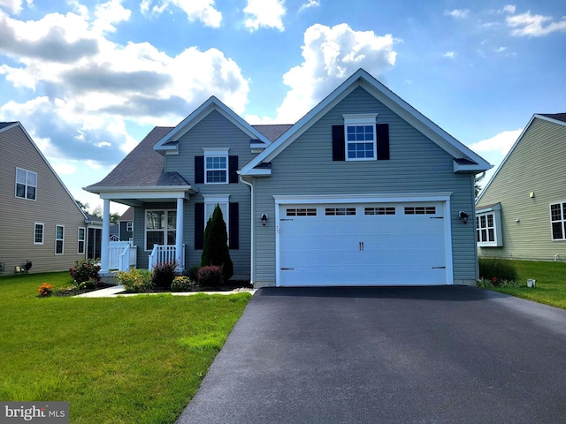 front of property with a garage, covered porch, and a front lawn