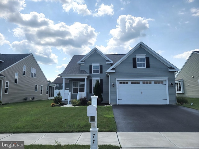 front facade with a garage, a front lawn, and covered porch