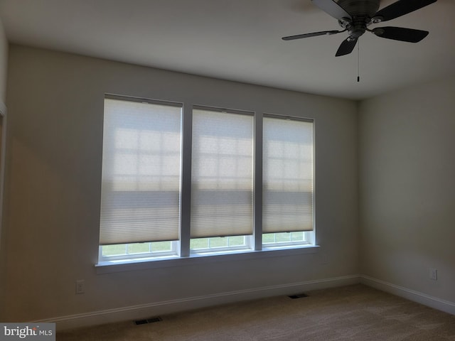 carpeted empty room featuring ceiling fan