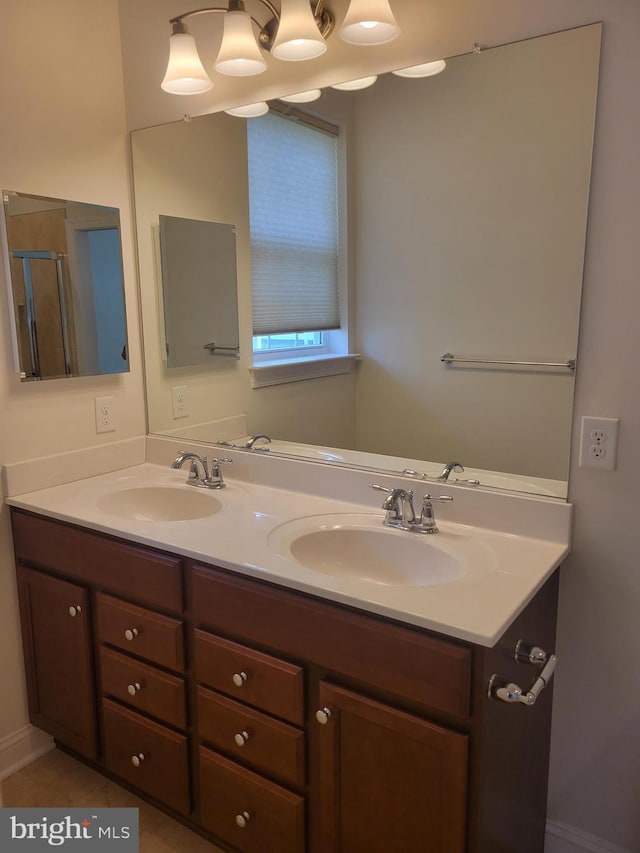 bathroom with vanity, an enclosed shower, and tile patterned flooring