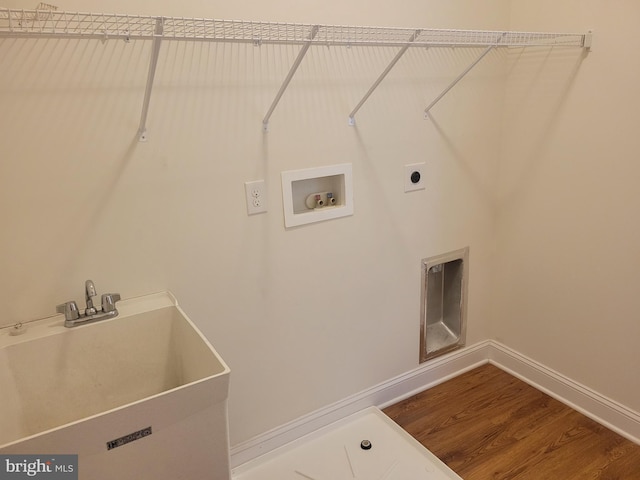 laundry room with hardwood / wood-style flooring, washer hookup, hookup for an electric dryer, and sink