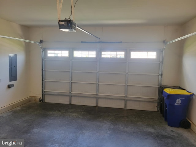 garage with a garage door opener and electric panel