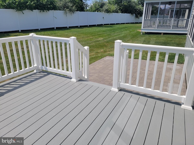 wooden terrace featuring a yard