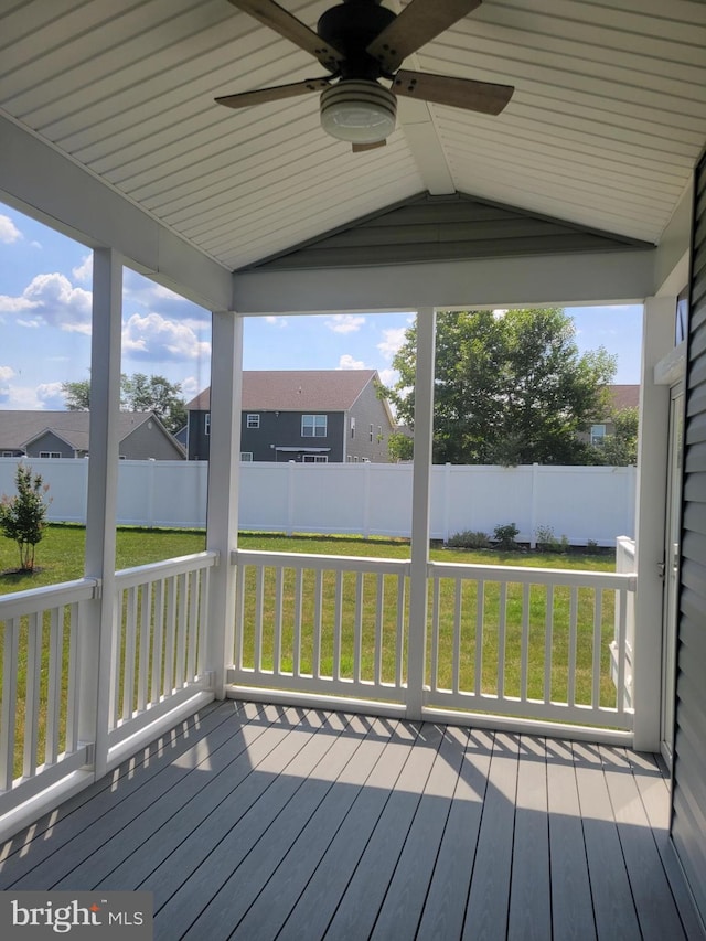 unfurnished sunroom featuring lofted ceiling and ceiling fan