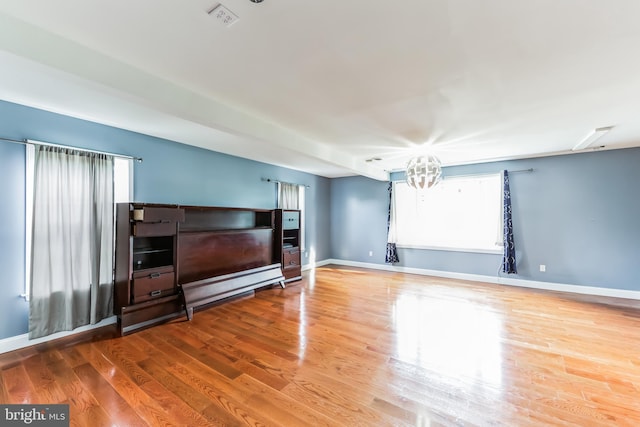 living room featuring a chandelier and light wood-type flooring