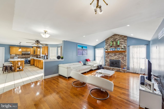 living room featuring a wealth of natural light, ceiling fan, and light hardwood / wood-style floors