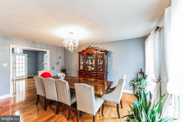 dining area featuring a notable chandelier and hardwood / wood-style floors