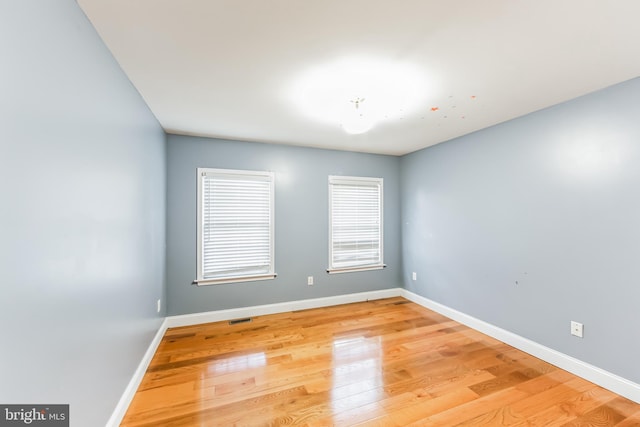 spare room with light wood-type flooring