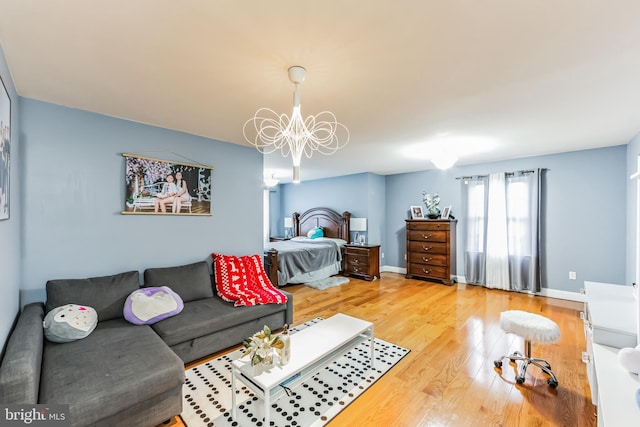 bedroom with a notable chandelier and light hardwood / wood-style flooring