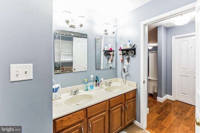 bathroom featuring dual vanity and hardwood / wood-style floors