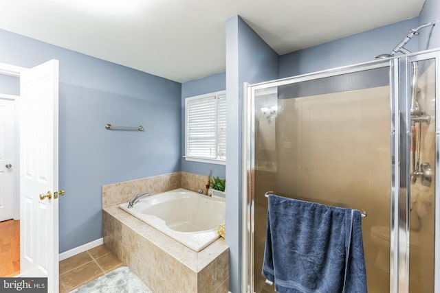 bathroom featuring tile patterned floors, plus walk in shower, and toilet