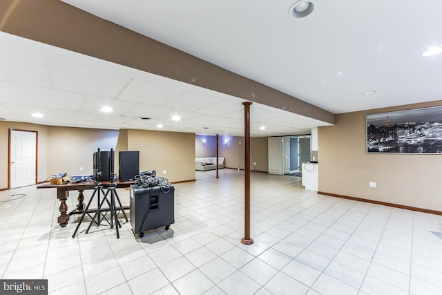 interior space featuring a drop ceiling and light tile patterned floors