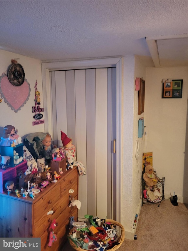 bedroom with a textured ceiling and carpet flooring