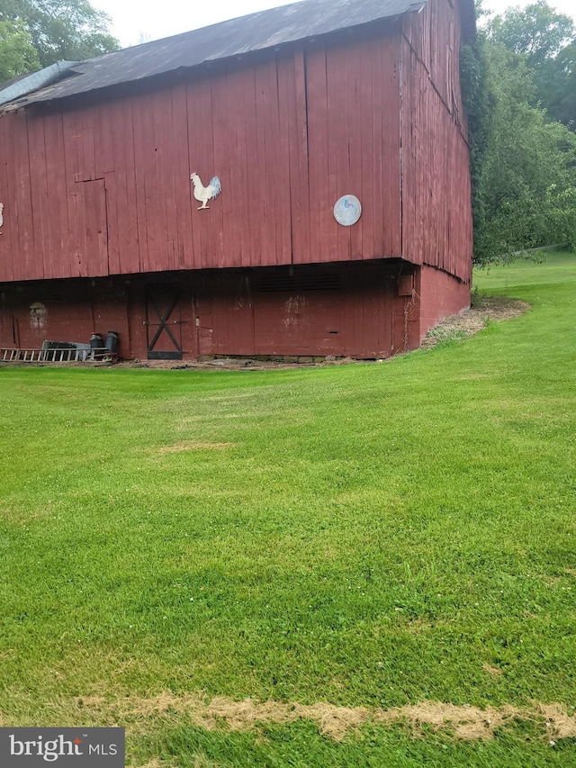 view of outbuilding with a lawn