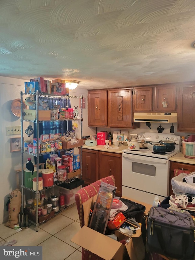 kitchen with electric stove and light tile patterned floors