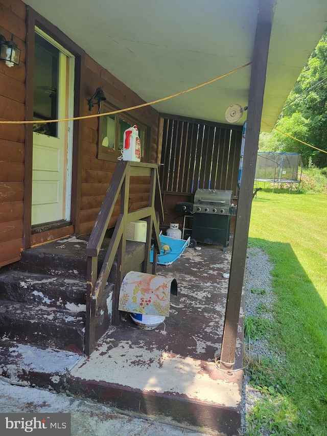 view of patio featuring area for grilling and a trampoline